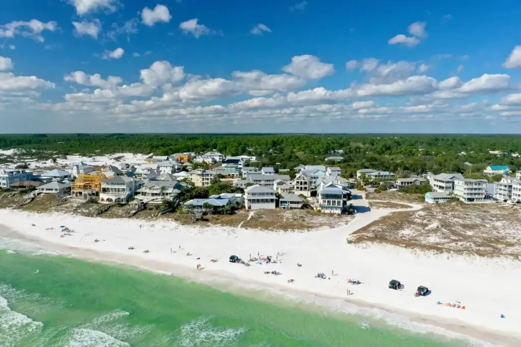 grayton-beach-village-beachfront-homes-beach-driving - Living on 30A Florida Aerial view of Grayton Beach village beachfront homes with permitted vehicles parked on the sand along the Gulf